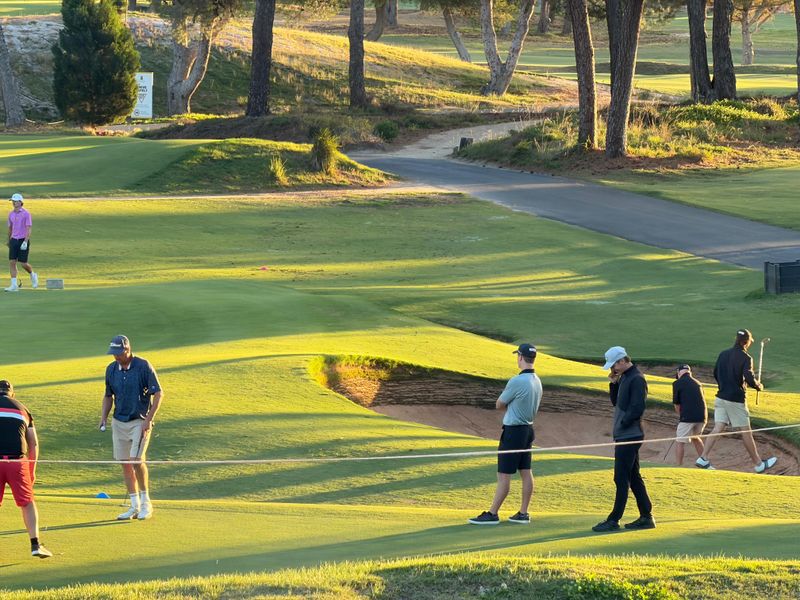 Golfers on the course at a country club event at golden hour